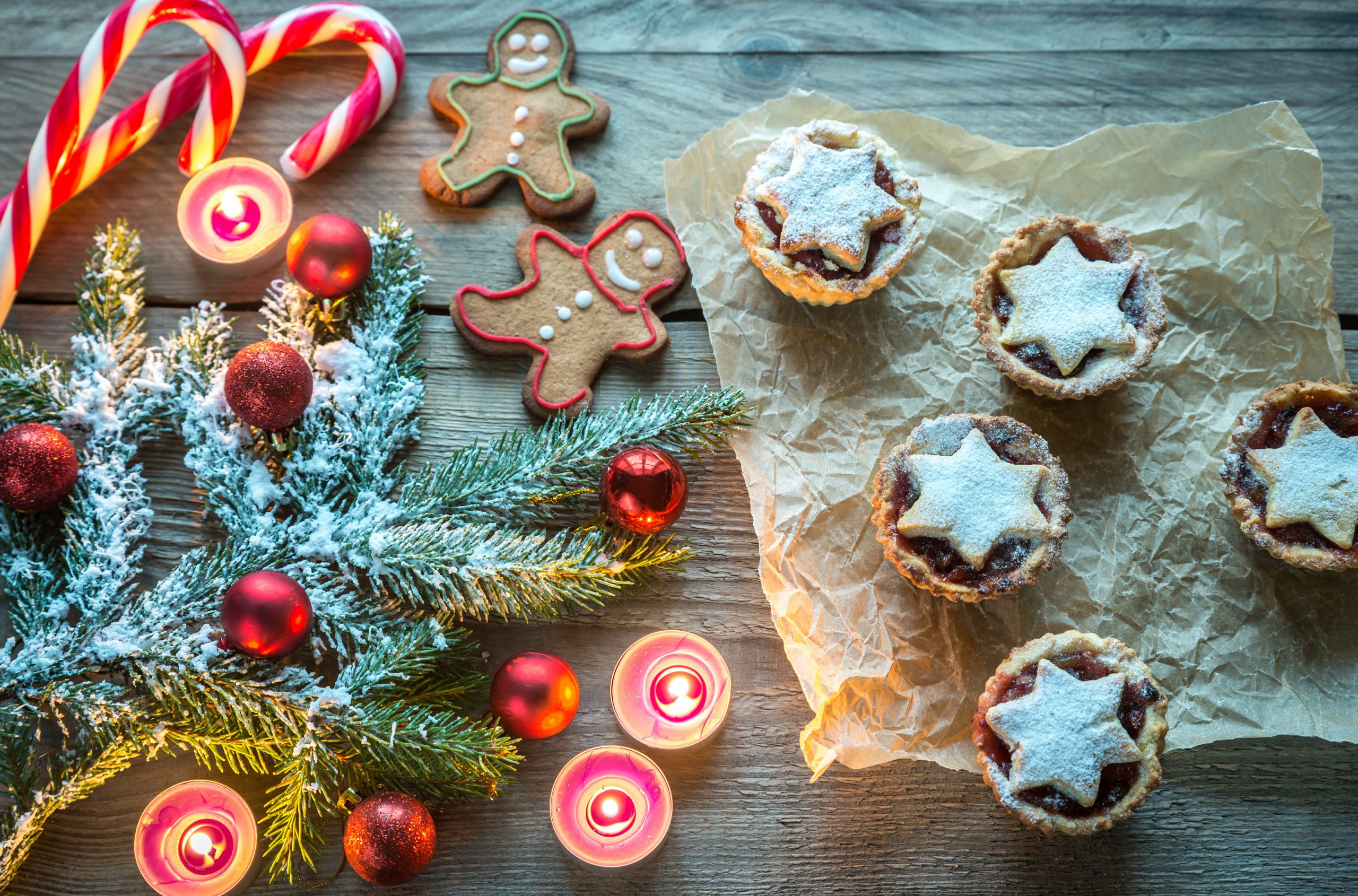 Festive baked treats packaged in gift boxes with ribbon on a kitchen counter